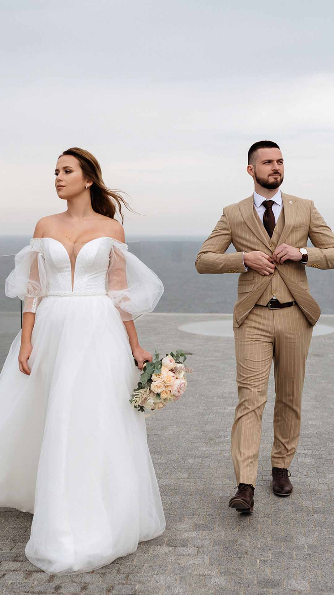 Bride and groom on a coastal terrace